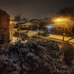 a chair in the snow at night