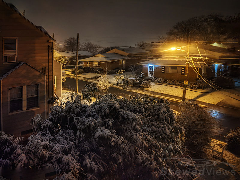 a chair in the snow at night